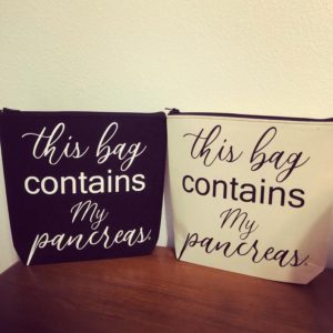 Zipper bags on a wood table with cream background. Dark bag with light writing on the left, light bag with dark writing on the right. Writing on both bags says, "This bag contains my pancreas"